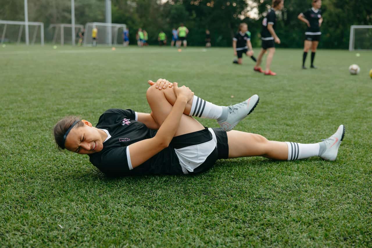 injured-athlete-lying-on-a-soccer-field